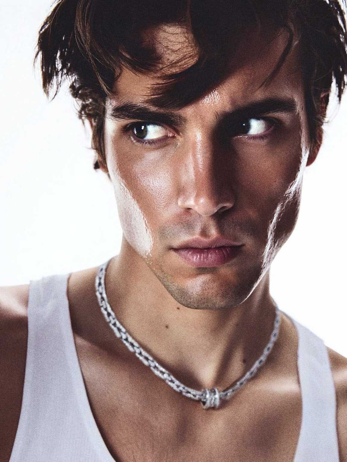 paparazzi zoom of Damon Cael in softly lit high-fashion look, rising pop artist Damon Cael.