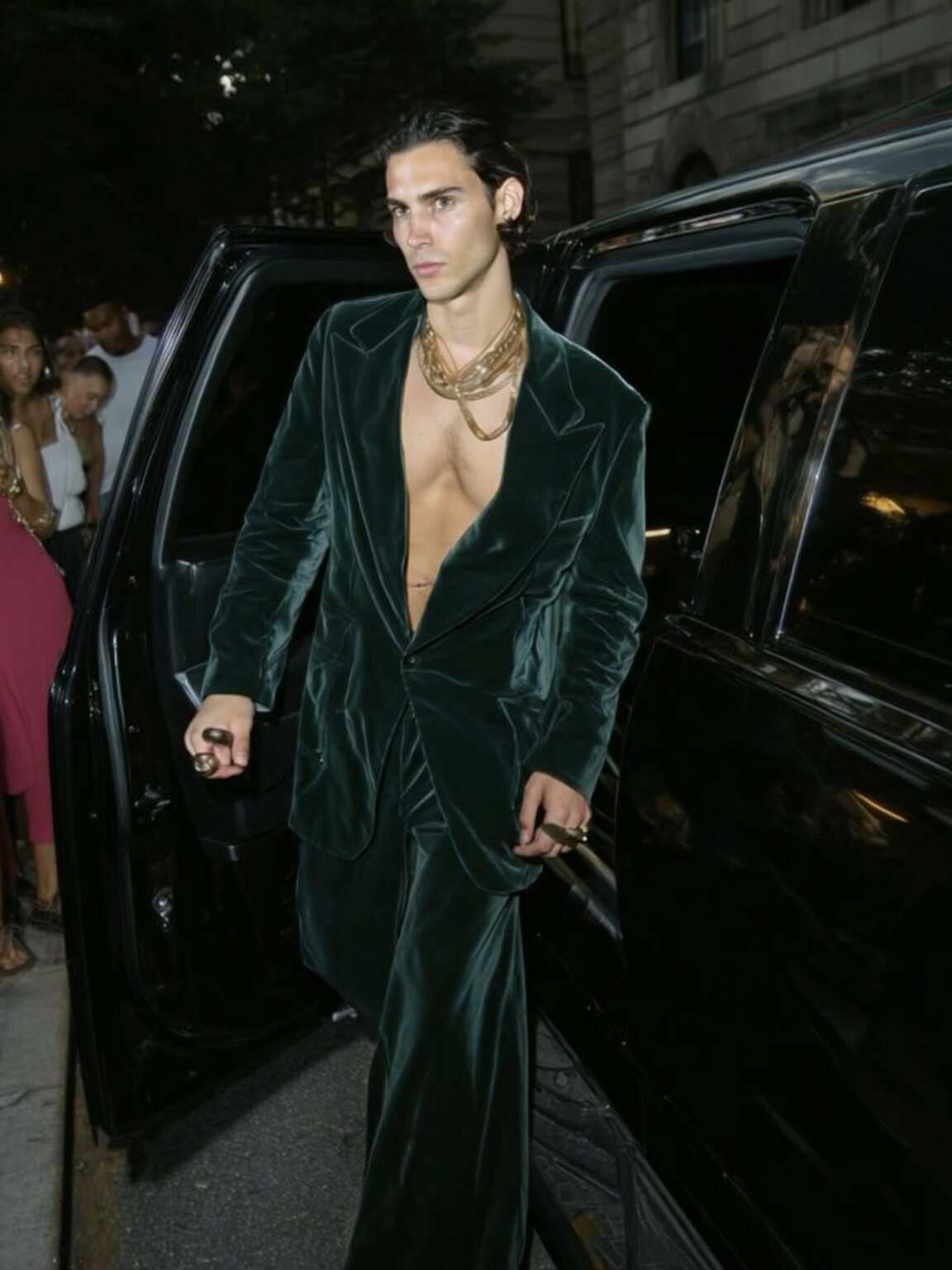 paparazzi-style doorway shot of Damon Cael in architectural jacket, rising pop artist Damon Cael.