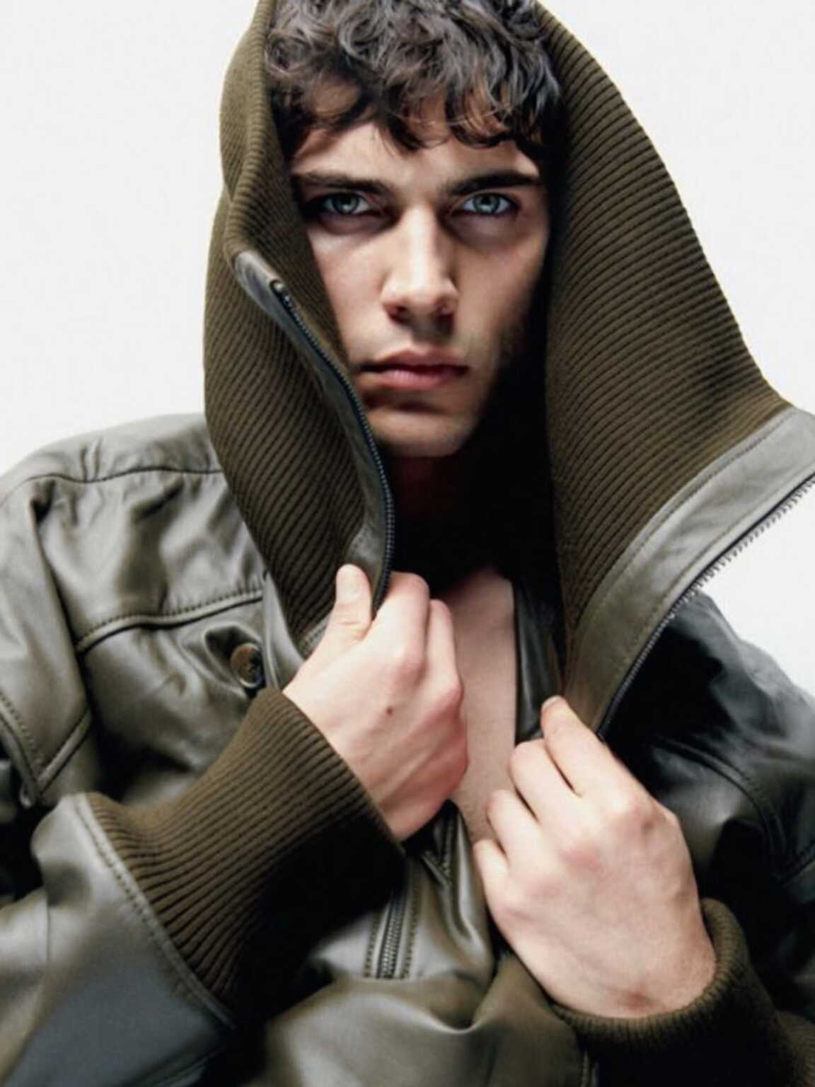 sidewalk flash capture of Damon Cael in futuristic layered look, rising pop artist Damon Cael.