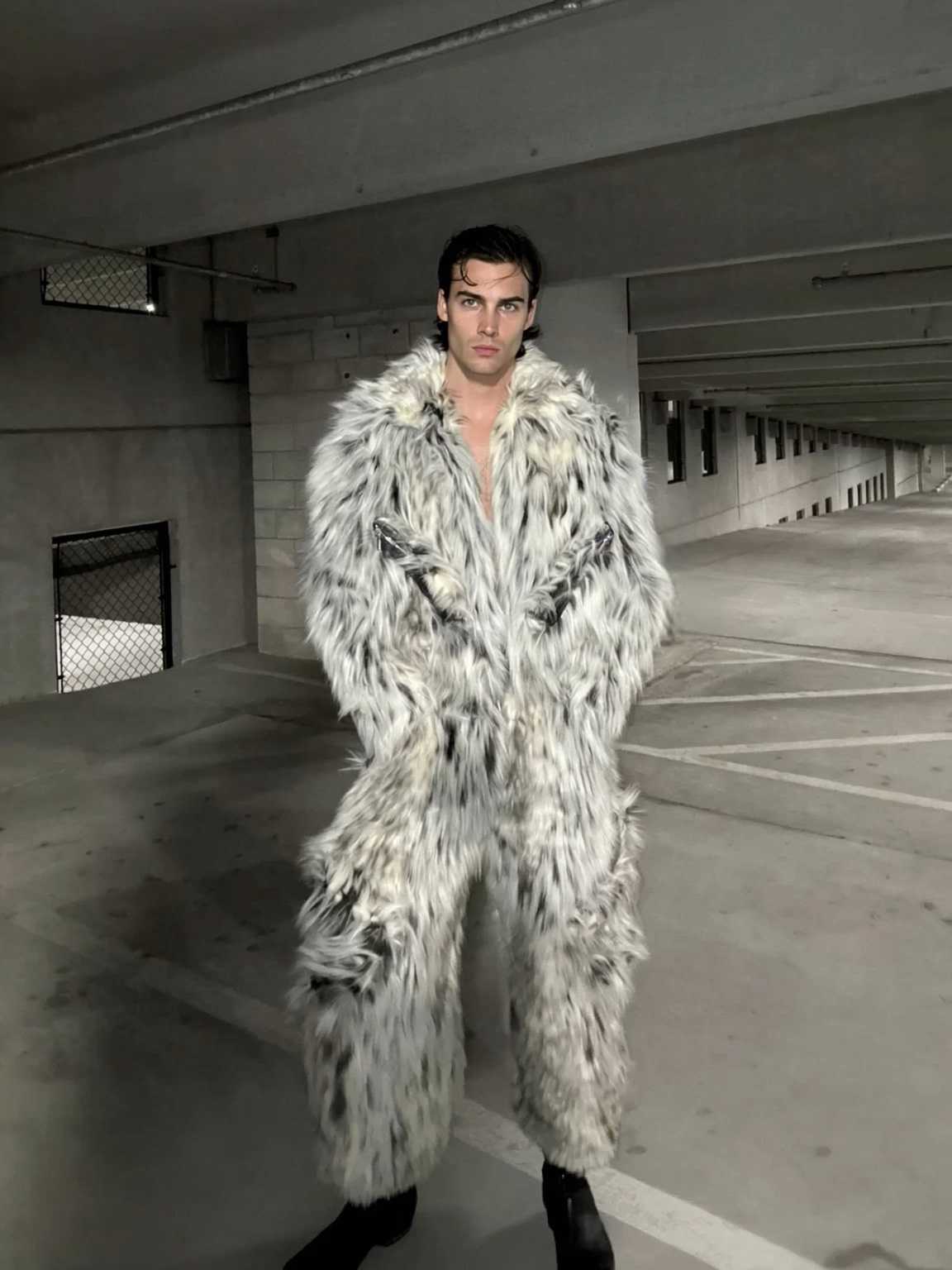 streetlamp-lit photo of Damon Cael in draped designer coat, rising pop artist Damon Cael.