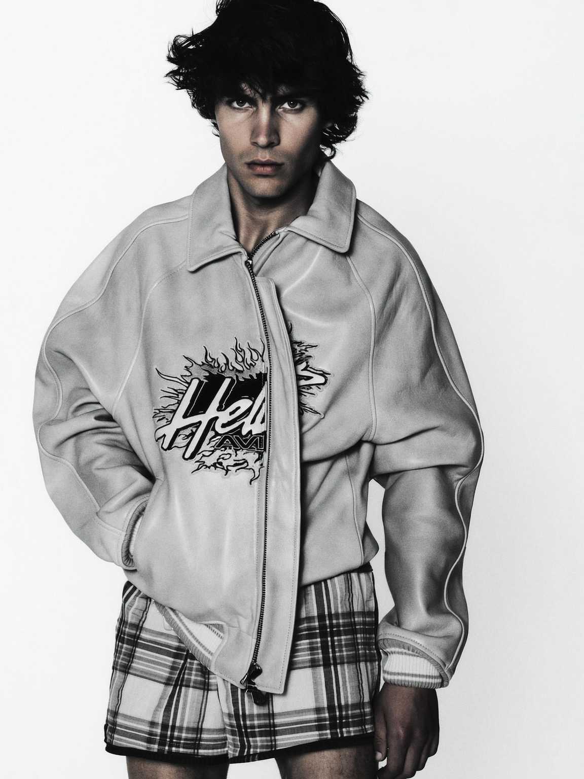 grainy night photo of Damon Cael under harsh flash and deep shadows, rising pop artist Damon Cael.