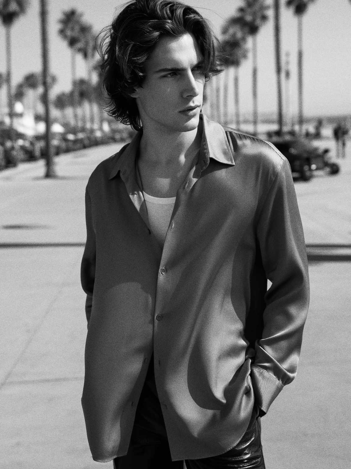 press-photo style capture of Damon Cael framed by blurred city background, rising pop artist Damon Cael.